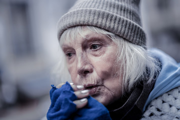 Portrait of a sad senior woman feeling cold