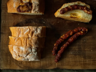 Ciabatta.Ciabatta Bread with sausage. homemade italian ciabatta bread top view. Bread with cheese. Sliced fresh bread on a wooden tray.