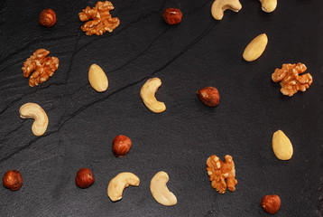 Fototapeta na wymiar Walnut, cashew, almond and hazelnut on black background.