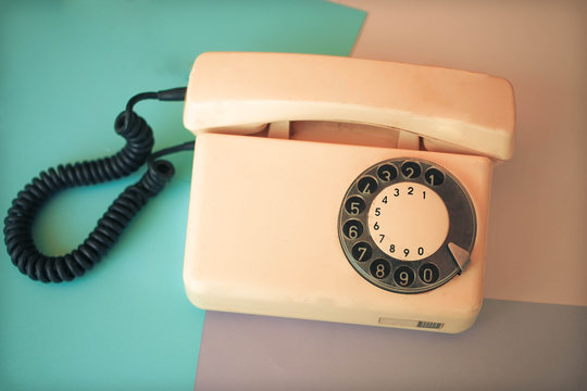 Telephone retro receiver over color background