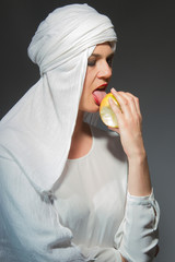 Beautiful woman  in white hijab licking