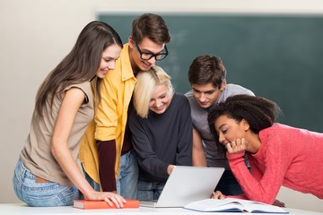Group of Students with computer at lesson in classroom