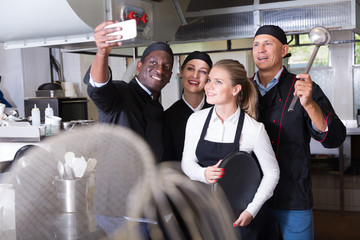 Team of restaurant staff making selfie