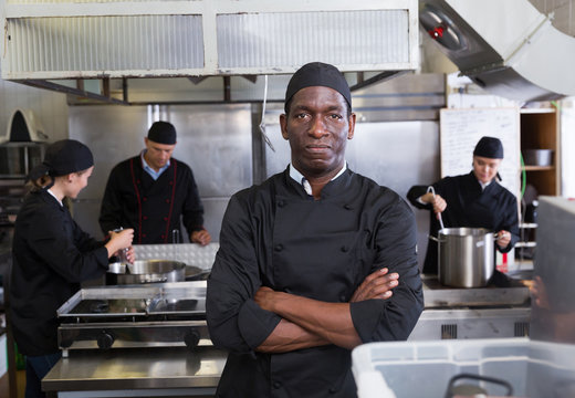 African-American chef in kitchen of restaurant