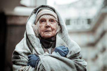 Portrait of a cheerless poor aged woman