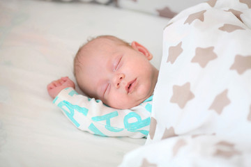 Newborn boy dream in a bed. Beauty, human