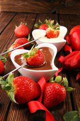Valentine Chocolate fondue melted with fresh strawberries and dark and white chocolate. Tublips and...