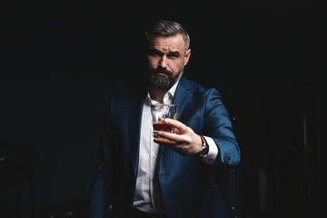 Attractive man with cigar and a glass whiskey