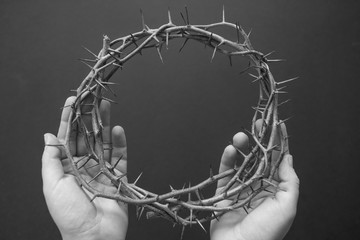 crown of thorns on hands easter background