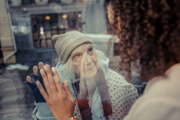 Pleasant afro American woman standing near the window
