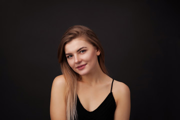 Fototapeta premium Young beautiful woman against dark background