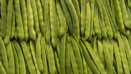 Market rows fresh green organic peas background. Healthy food
