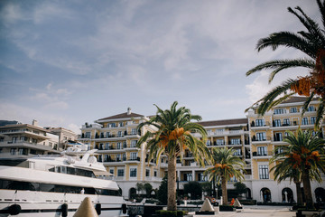 Luxury white yachts stand at the bay before luxury hotel