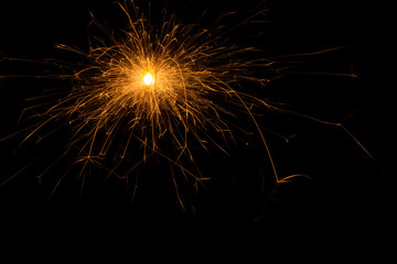 Bengal fire. New year sparkler candle on black background