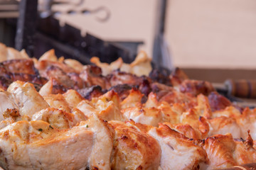 A man fries a barbecue of pork meat and a grill on the back of the chicken meat