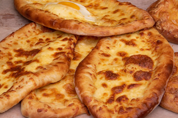 Khachapuri Adzharian Georgian cuisine closeup with egg, the Georgian cuisine. Street food.