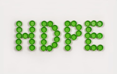 HDPE (High-density polyethylene) lettering composed of caps from plastic beverage bottles. Recycling.