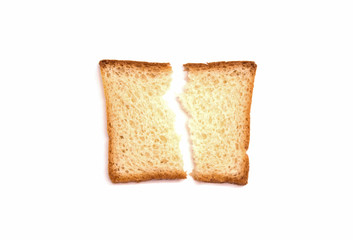 one broken piece of white bread toast lies on a white background
