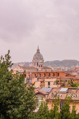 Fototapeta na wymiar View of roofs and churches domes in Rome from Pincio hill, Italy