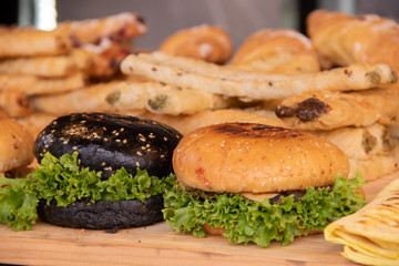 Hamburgers with white and black flour, meat cutlets and greens, no street food festivals