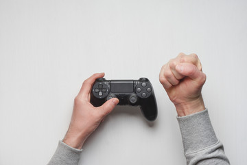 Hand hold new joystick isolated. Gamer play game with gamepad controller. Gaming man holding simulator joypad. Person with keypad joystic in arms. Sleeve hands hold toy equipment. Modern manipulator.