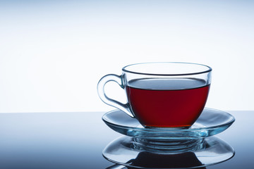 Glass cup of hot aromatic tea on white background. Close up.