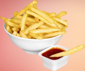 Paper box with pile of appetizing french fries over white planks
