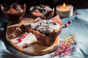 Chocolate muffins on a wooden desk