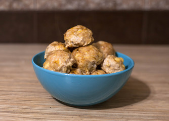 Fried chicken patties in a blue plate on the table