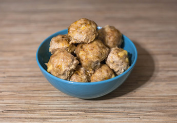 Fried chicken patties in a blue plate on the table