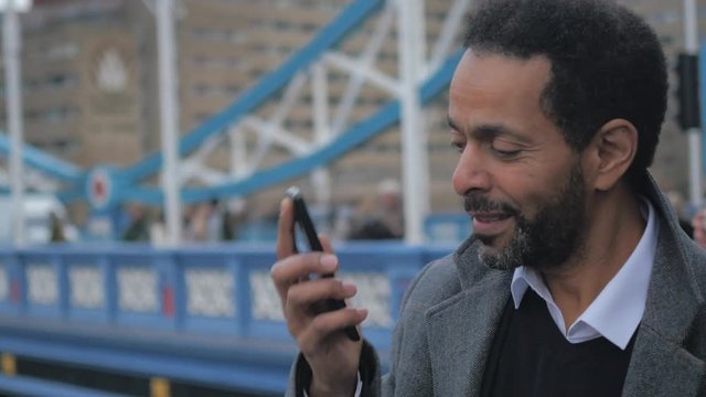 Happy man talks on the phone with a friend