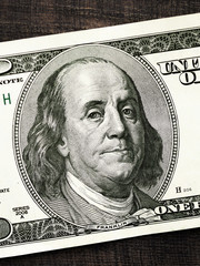 Benjamin Franklin's portrait on one hundred dollar bill close up