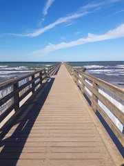 Traditional wooded sea bridge pier with nobody against baltic sea