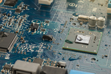 Part of the electrical circuit motherboard covered with water droplets. Close up image, selective...