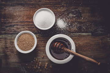 different kinds of sugar and maple syrup on a background