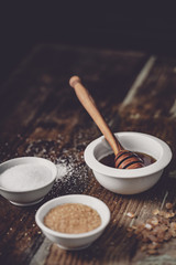 different kinds of sugar and maple syrup on a background