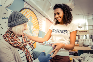 Cheerful friendly woman giving a nice present