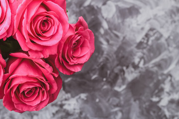 Romantic background. Red roses on a concrete table. Copy space. Top view. Flat lay