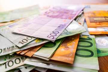 Euro banknotes in salary envelope. Open envelope with money banknotes on table. White envelope with Euro bills. Closeup on Envelope full of euro cash. Euro money currency. International monetary