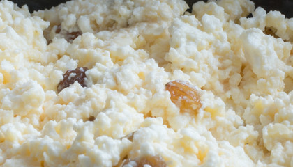 Close up of cottage cheese, curd with raisins. Healthy food consept - protein and calcium