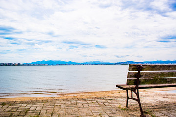 Fototapeta na wymiar empty bench on the beach
