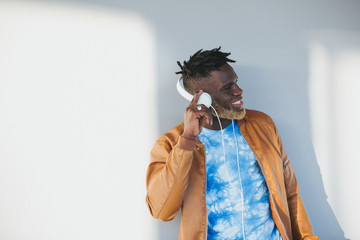 Black afro american man wearing headphones and listening to music