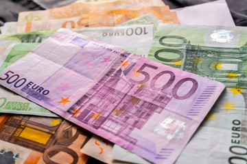 Euro banknotes in salary envelope. Open envelope with money banknotes on table. White envelope with Euro bills. Closeup on Envelope full of euro cash. Euro money currency. International monetary