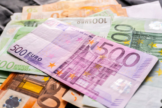 Euro banknotes in salary envelope. Open envelope with money banknotes on table. White envelope with Euro bills. Closeup on Envelope full of euro cash. Euro money currency. International monetary