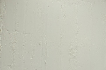 Texture of white flour on a dark wooden background.