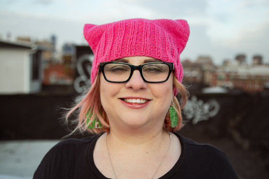 Proud Feminist Woman Wearing An Iconic Pussyhat On A Manhattan Rooftop. 