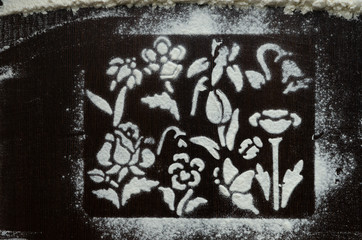 Texture of white flour on a dark wooden background in the form of a frame with flowers.