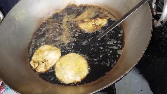 January 4, 2018. Kolkata India. Frying of Kachuri in oil in a sweet snack shop. Kachuri is a famous indian snack.