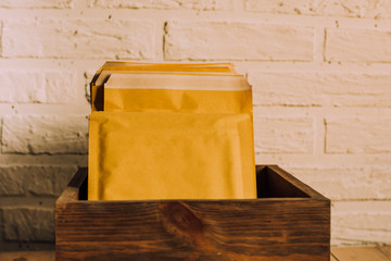 Mailings. Parcels in envelopes. Packaging for letters. Forward small orders by mail. Delivery orders. Stack of envelopes. Search for orders. Letters in box.
