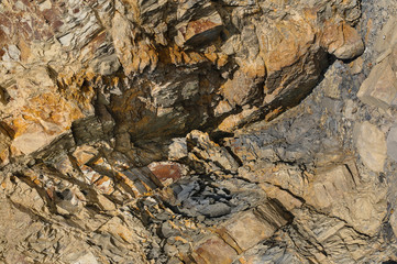 Texture of a dark yellow granite stone or background for design..Surface of the rock with an abstract pattern.